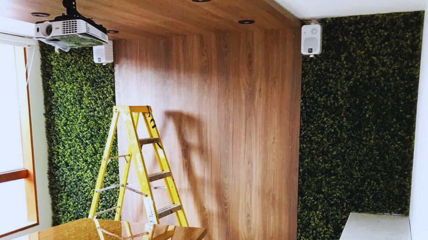 Step-by-step indoor installation of artificial green wall panels on wooden surface, practical guide for living wall coverage