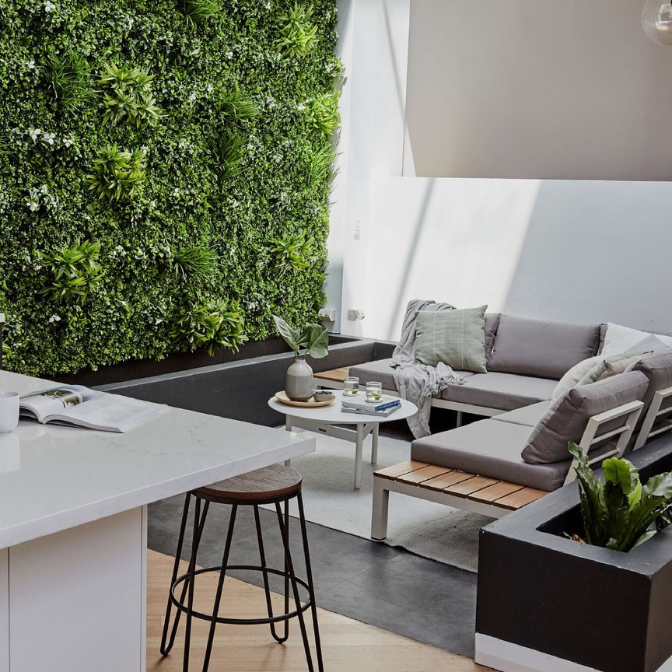 Artificial green wall panels in modern indoor patio living space