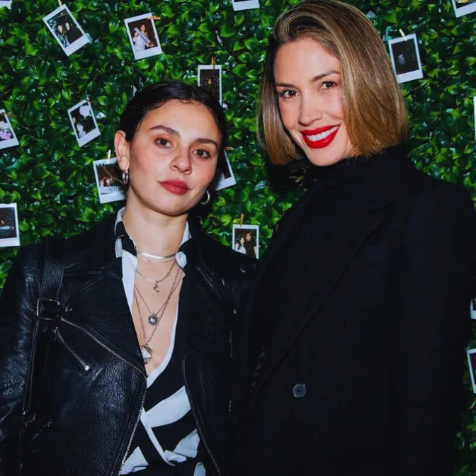 Artificial foliage wall decorated with hanging instant photos creating a memory backdrop for events and parties