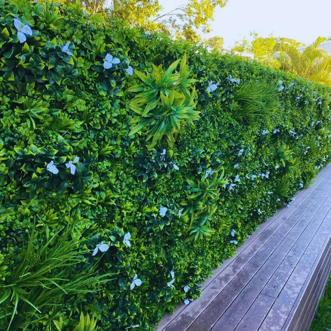 Outdoor artificial green fence panels with UV protection used as a privacy wall for backyard spaces