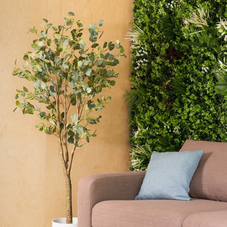 Indoor living room with artificial green wall panel and modern sofa decor