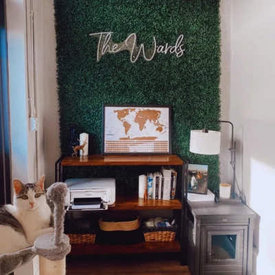 Artificial boxwood green wall installed in modern home office with custom signage used as decorative accent wall