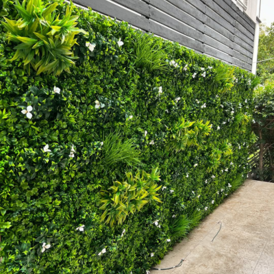 Artificial hedge wall 40"x40" Black Forest with tropical greenery and white flowers, outdoor artificial foliage panel for backyard privacy.