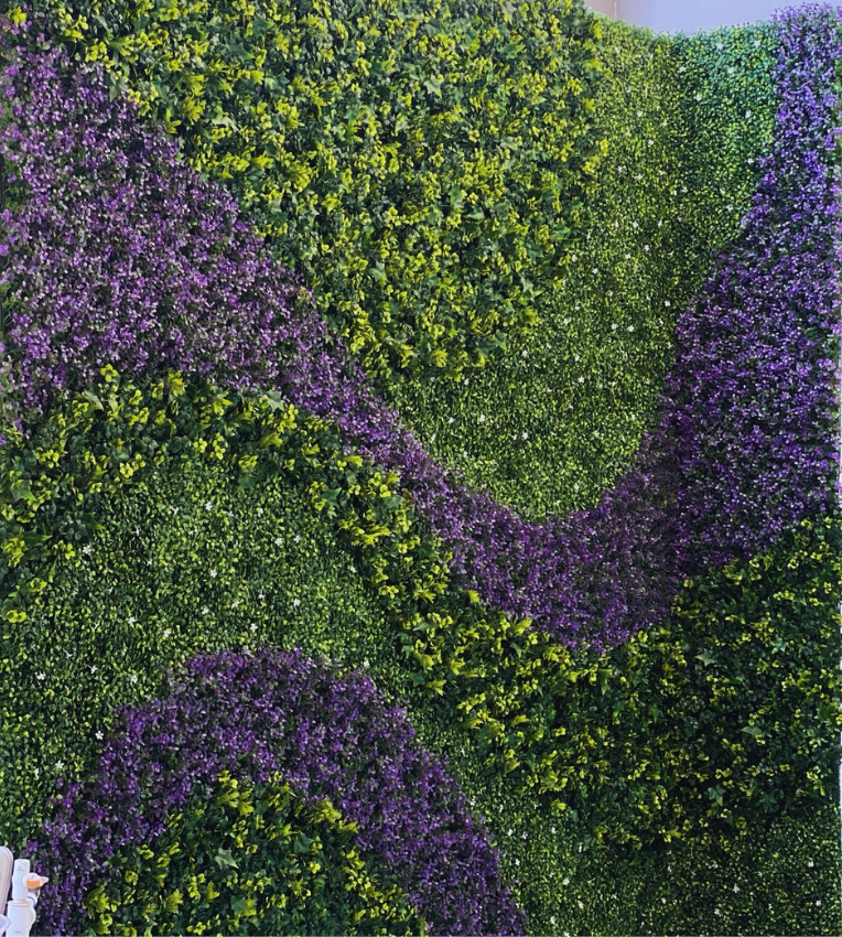 Realistic rendering of artificial green wall with purple and green foliage wave pattern for custom vertical garden design
