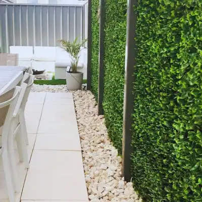 Outdoor patio with Gardenia Leaf Artificial Hedge Wall Panels 40