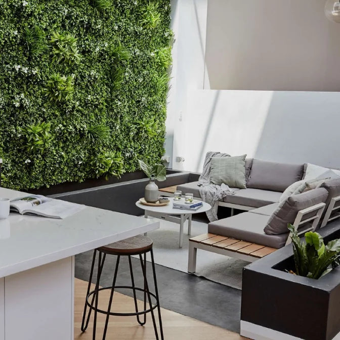 Artificial green wall panels installed in modern indoor patio living space as decorative accent wall