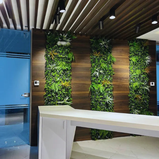Reception area with artificial green wall panels by Green Warehouse, creating a modern and welcoming indoor space with lush greenery.